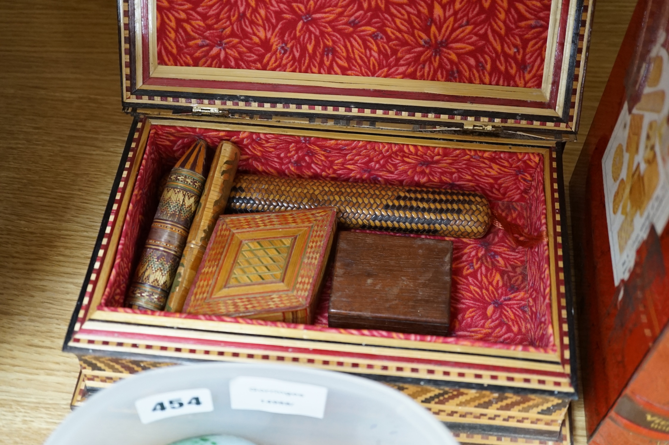 Sundry items to include glass eggs, marbles, a set of three tins in the form of books and a straw work box, etc. Condition - mostly fair